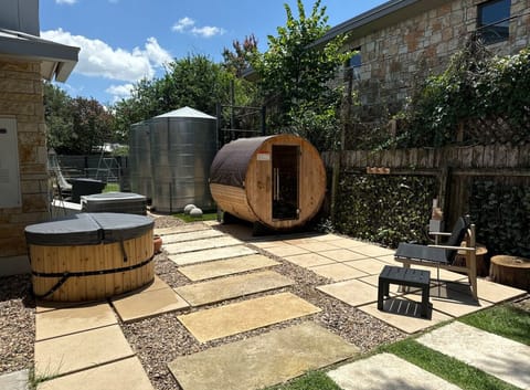 Wellness oasis with outdoor barrel sauna for up to 4 adults and cold plunge.