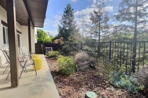 Exit master bedroom to a peaceful patio with four chairs and olive orchard views,ideal for relaxing.