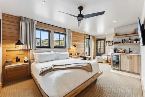 Suite Interior: King bed, 55” Smart TV, Bluetooth speaker, humidifier, dining nook, kitchenette