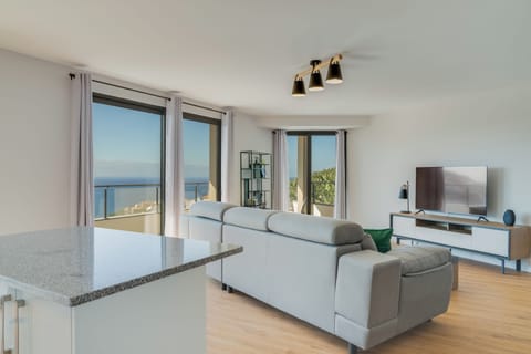 Comfort Apartment | Living area | 65-inch TV with cable channels