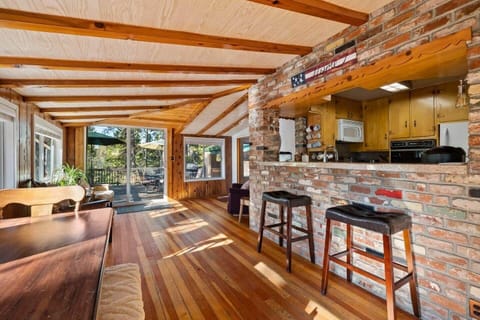 Indulge in the perfect harmony of mountain charm and breathtaking scenery!  This inviting space boasts an interior brick wall, a bar with a view and abundant amount or natural light cascading through the windows.  #mountainviewescape