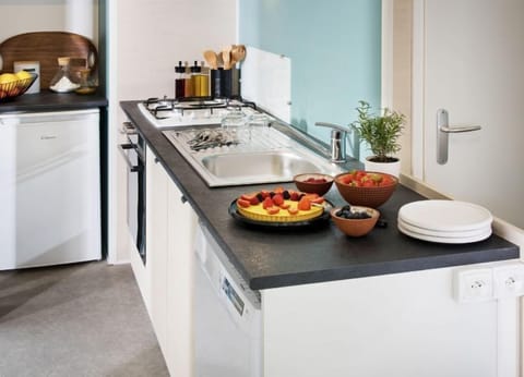 This stylish kitchen area, equipped with contemporary appliances, invites families to prepare delicious meals in comfort and convenience.