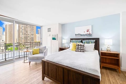 Bright studio with a queen bed, and private balcony offering city views.