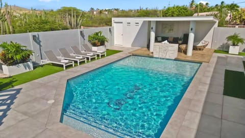 Refreshing outdoor pool perfect for swimming, relaxing, sunbathing, and enjoying tropical weather year-round.