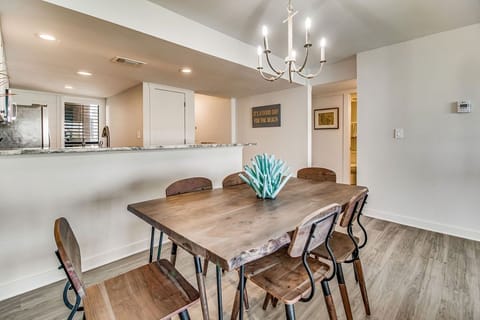 Dining table with seating for 6 and crystal chandelier at Wind Drift Orange Beach waterfront