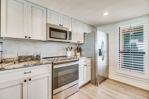 Fully equipped kitchen with white cabinets and granite counters at Wind Drift Orange Beach waterfront rental