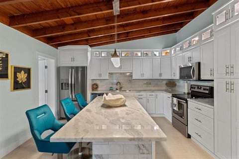 The full kitchen with a center island and stools.