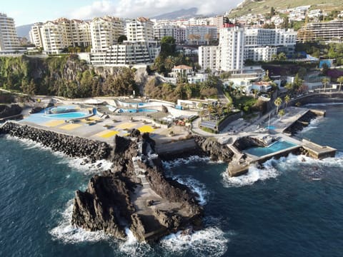 Beach nearby, black sand, sun loungers, beach umbrellas