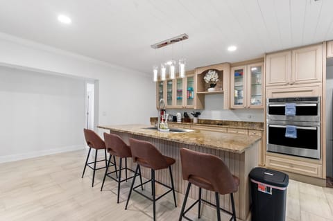 Spacious kitchen with appliances, cutlery, dishes, spices, etc.