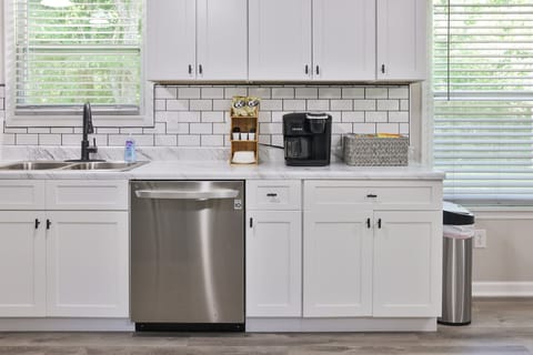 Keurig coffee pot with coffee and all the condiments and some snacks