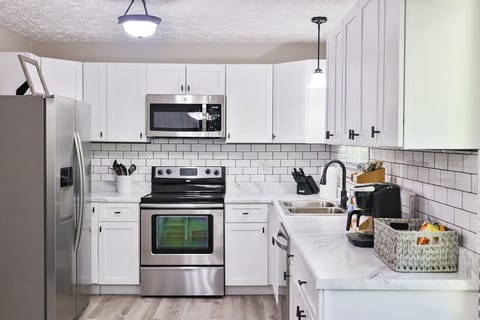 Updated kitchen with new cabinets, counters, stainless applcs & tile backsplash