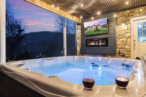 Cozy up by the electric fireplace in the oversized hot tub, while enjoying a beverage of choice and watching your favorite show, movie or sports team - rain or shine.