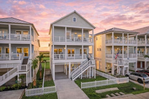 Stunning multi-level beach house with coastal architecture, private driveway, white picket fencing, and spacious balconies—perfect for a relaxing seaside vacation.

2.