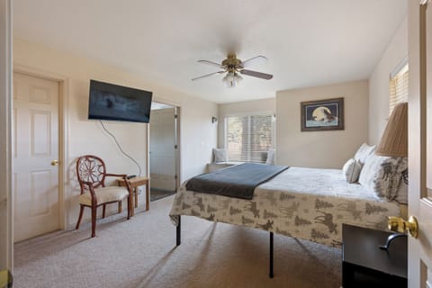 Settle into your cozy bedroom sanctuary with crisp linens, mountain artwork, and gentle ceiling fan breeze for perfect sleeping comfort.