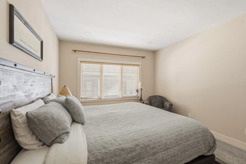 Sink into your peaceful sanctuary with a plush bed and soft natural light streaming through blinds for restful mornings.