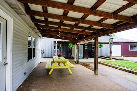 Outdoor covered picnic area, gas grill, rockers and swing