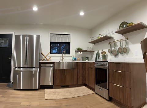 Full kitchen with brand new appliance, quartz countertops and all necessities