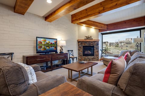 Sink into plush sofas beside your cozy fireplace, watching shows on the flat-screen TV while exposed beams frame your mountain getaway.
