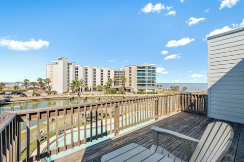 Relax on your private deck with pool and marina views, where coastal breezes and sunny skies create the perfect backdrop for morning coffee.