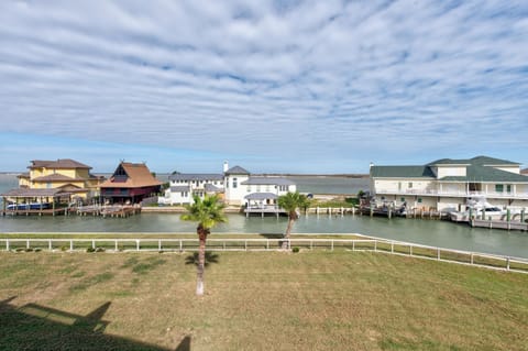 Waterfront community with canal access, featuring docked boats and coastal homes under expansive Texas skies.