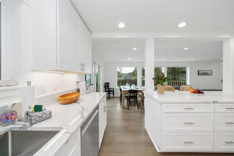 Open living space with living room with cable and streaming TV, electric fireplace, Dining table for 8, breakfast bar for 2 and Open to newly remodeled kitchen with all new appliances.