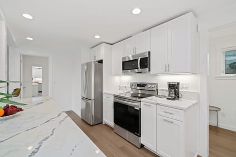 Open living space with living room with cable and streaming TV, electric fireplace, Dining table for 8, breakfast bar for 2 and Open to newly remodeled kitchen with all new appliances.