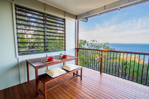 Rear deck with dining setup and ocean outlook. Scenic, private space for guests.