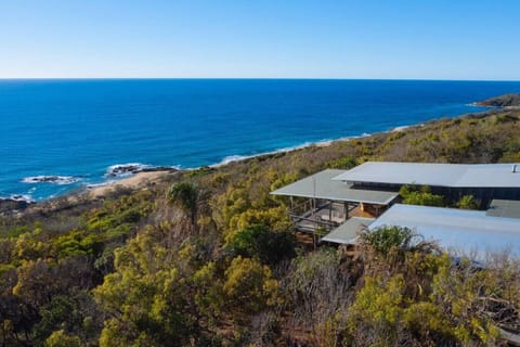 Modern hillside home with panoramic ocean views and open decks, offering a private retreat within Sunrise at 1770.