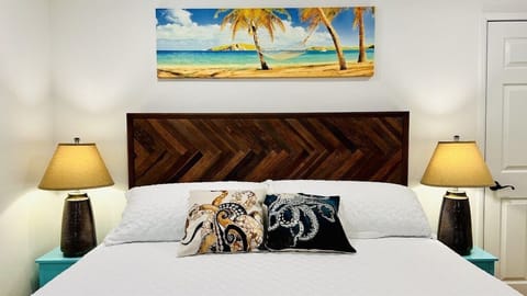 King sized bed with quality linens and pillows can be found in the main bedroom