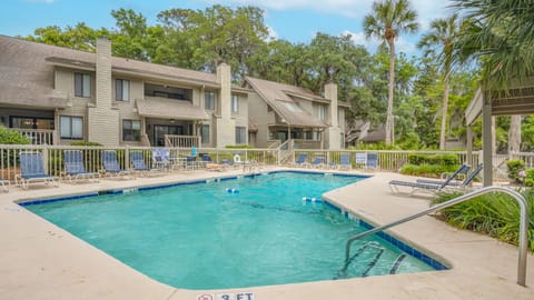 The spacious deck offers plenty of lounge seating for relaxing in the sun or shade, while the adjacent pavilion provides a comfortable spot to cool off between swims.