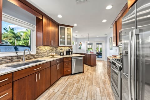 Sleek solid‑wood cabinets, granite countertops, and a bright, airy layout perfect for cooking and entertaining.