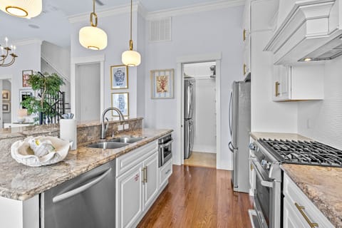 Your dream kitchen awaits with granite counters, stainless appliances, and warm pendant lighting perfect for cooking memorable meals.