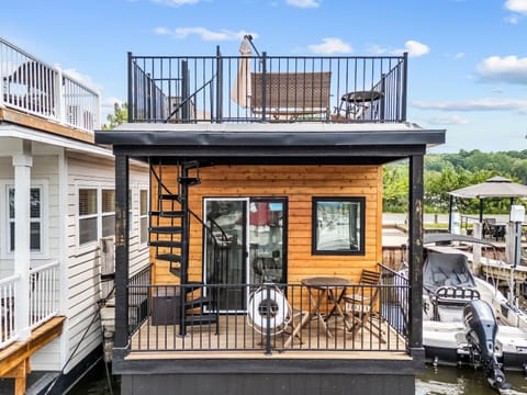 Welcome to Shoreside Haven, a charming floating cottage offering two private outdoor spaces to soak up marina life.