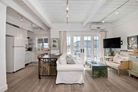 Kitchen and living area with flat screen TV.