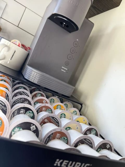Coffee bar with k cups, creamer, and Torn syrups