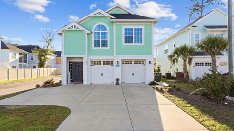 Bright coastal home with spacious driveway and garage