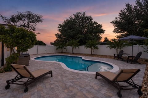 Twilight poolside evenings made for relaxing after a beach day — your private backyard oasis awaits