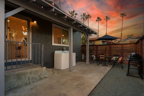 Enjoy relaxing evenings on the private patio with string lights, outdoor dining, and beautiful sunset skies.