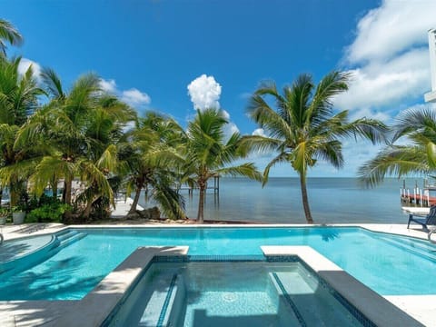 Soak in breathtaking bay views from your private pool and spa surrounded by swaying palms.