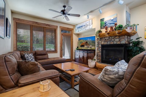 Sink into plush leather seating by your crackling stone fireplace, where mountain views and rustic charm create the perfect retreat.