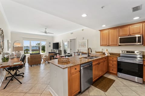 The fully equipped kitchen features granite countertops and stainless-steel appliances.