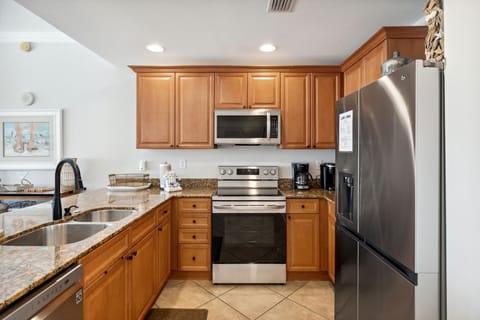 The fully equipped kitchen features granite countertops and stainless-steel appliances.