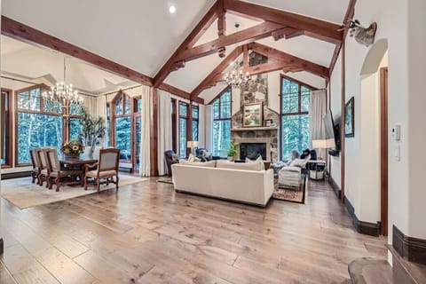 Relax in our spacious living room, where comfort meets elegance. Unwind by the cozy gas fireplace or step onto the private balcony, surrounded by luxurious seating and breathtaking mountain views. with easy access to the dining room/private balcony.