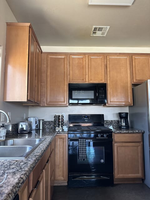 The large kitchen is equipped with what you need to cook a meal.