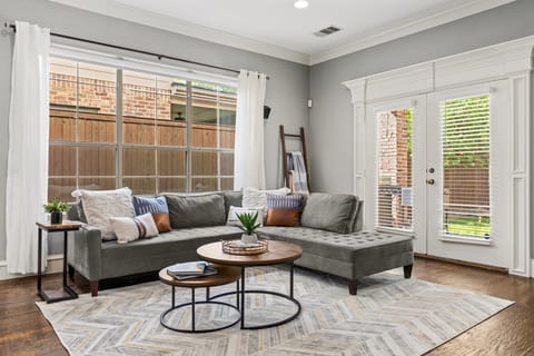 There is ample seating and great lighting in the open concept living room. For those overly bright and sunny days, the electric blinds can be closed to ensure everyone is comfortable in the living room.
