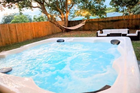 new hot tub, hammock, outdoor sectional, string lights, outdoor games, BBQ. 