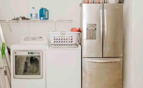 Laundry area in garage and extra fridge