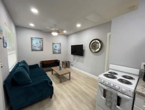 Comfy large couch and additional bench for seating. Large flat-screen smart TV.