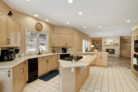 Full kitchen opens to back family room with fireplace, bar seating, and an eat in area for the entire family to prep, cook meals, and eat.