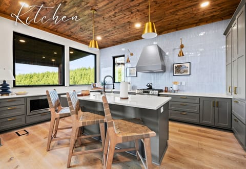 Let the outside in while you cook in our airy kitchen, framed by forest views. It's the perfect mix of modern amenities and natural serenity.